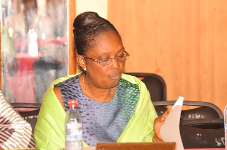 Health Minister Bernice Dahn peruses some documents before the meeting